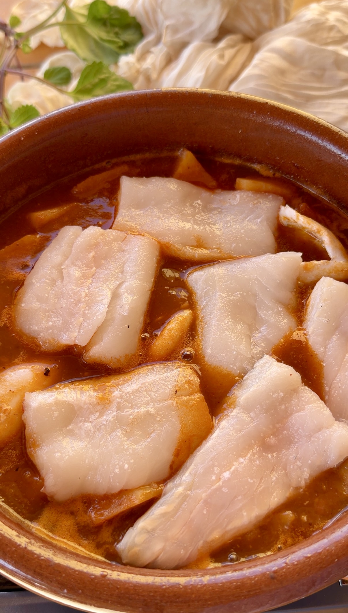 Supremas de merluza sin espinas añadidas a la cazuela sobre las patatas cocidas.
